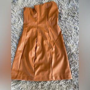 Faux leather mini dress . Easy zip up zip off with stretch .